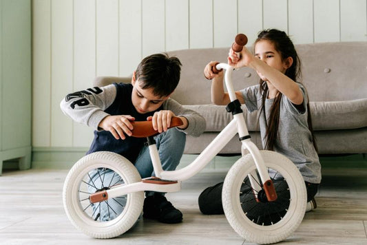 two children fixing a bike